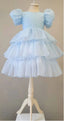 WHITE LAYERED ELEGANT GOWN FOR BIRTHDAY SPECIAL OCCASIONS WITH TIARA AND TULLE GLOVE COMBINATION CAN BE WORN WITH A LONG OR SHORT BACK DESIGN