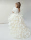 WHITE LAYERED ELEGANT GOWN FOR BIRTHDAY SPECIAL OCCASIONS WITH TIARA AND TULLE GLOVE COMBINATION CAN BE WORN WITH A LONG OR SHORT BACK DESIGN